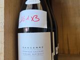 a bottle of wine that is sitting on a shelf