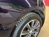 a close up of a car ' s tire with a sticker on it