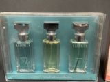 two bottles of perfume are in a clear box on a table