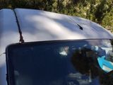 a white car with a surfboard on top of it