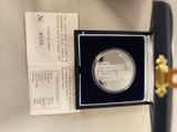 an image of a silver coin in a black box on a table