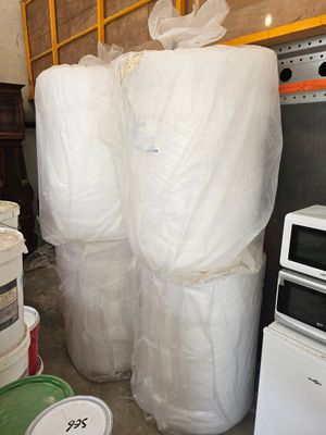 une pile de paquets de papier toilette à côté d'un micro-ondes