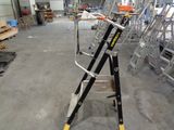 a ladder that is sitting in a room with many ladders