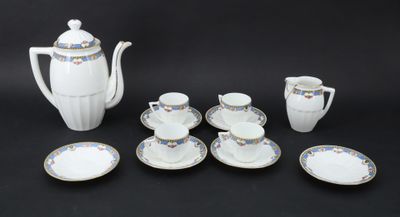 an image of a white tea set with blue and gold accents