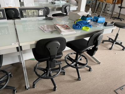 a glass table with a bunch of chairs around it