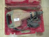a drill in a case with a cord in it