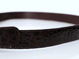 brown leather belt with a buckle on a white surface