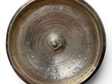 a metal object that is sitting on a white surface