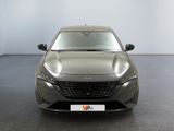 the front of a grey car in a room with a white wall