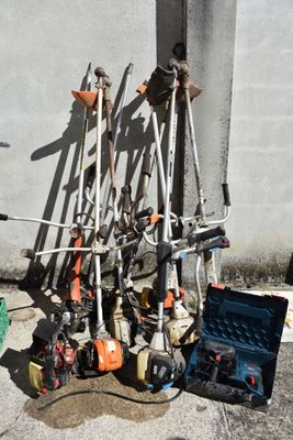 a pile of skis and ski poles on the ground