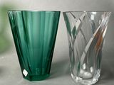 two green vases sitting next to each other on a table