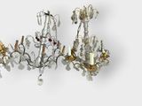 pair of silver and gold chandeliers with crystals on them