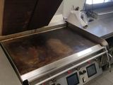 stainless steel counter top in a commercial kitchen with a large oven