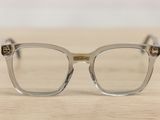 a pair of glasses sitting on a wooden table