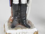 figurine of a man in uniform with a sword and shield