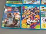 a lot of wii games on display on the table