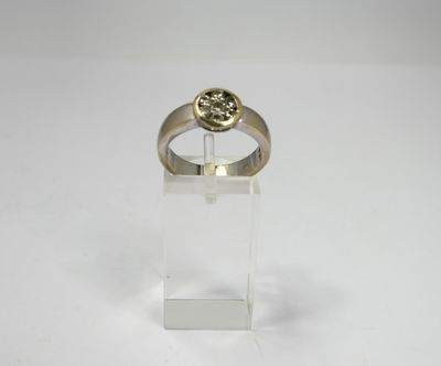 a close up of a gold ring with a stone in the center