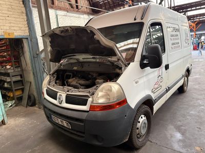 a white van with the hood open in a garage