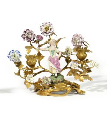 an image of a figurine of a woman with flowers on a stand