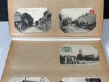 an old photo of a book with pictures of buildings and people in it