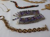 many different types of jewelry displayed on a table