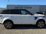 a picture of a white land rover parked in front of a building
