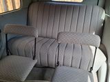 a seat in the back of a bus that is empty