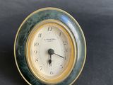 a small clock that is sitting on a table