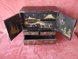 a small wooden box with two drawers inside of it