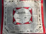 a red and white pillow with a map on it