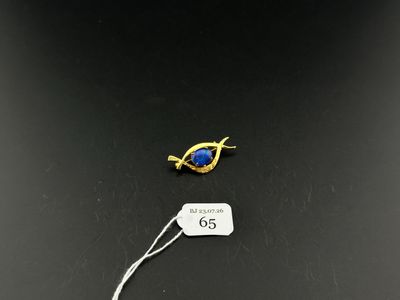 a close up of a piece of jewelry with a tag on it