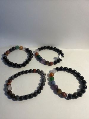 three bracelets with black onyx beads and multi colored stones
