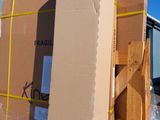 a large cardboard box sitting on a pallet in front of a building