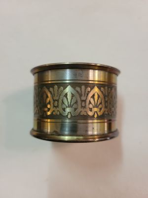 a silver ring with a design on it