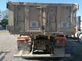 a dump truck that is parked on the side of the road
