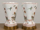 two vases that are sitting on a table