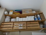 a shelf that has many boxes and containers on it