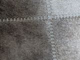 a close up of a carpet with a patch in the middle of it