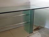 a glass table with a glass shelf on top of it