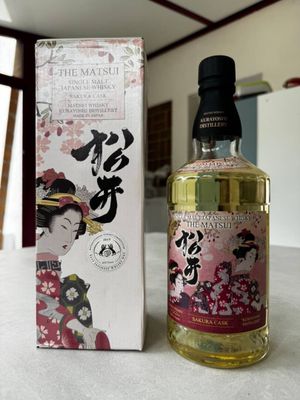 an image of a bottle of alcohol sitting on a table next to a box