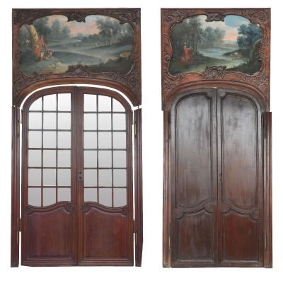 pair of antique painted wood doors with arched glass panels