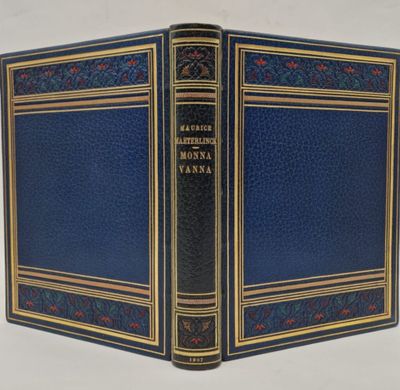a blue book with gold trimming and a black cover
