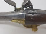 a close up of a gun on a white surface