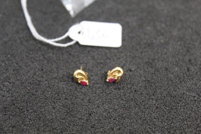 a small pair of earrings that are laying on a table