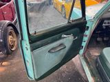 an old car with a broken door and a broken window