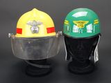 two helmets are sitting on top of each other on a black surface