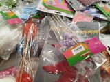 a pile of craft supplies on a table next to a cup of coffee