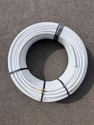 a close up of a white pipe laying on the ground