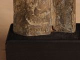 statue of a man and a woman on a wooden base