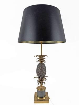 a close up of a lamp on a table with a black shade